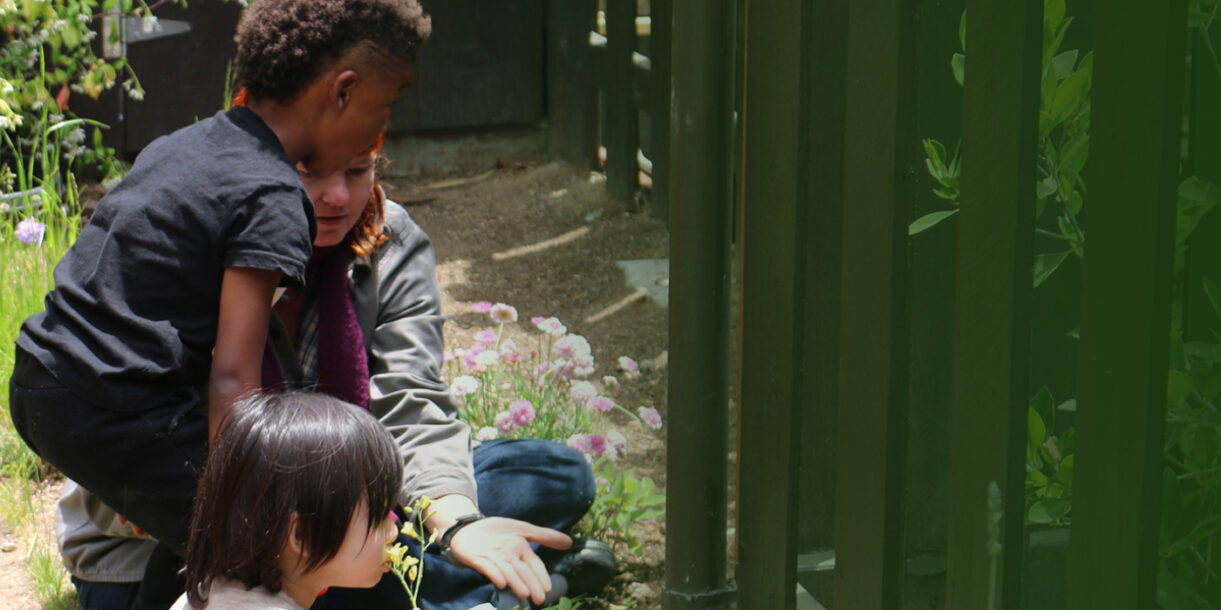 teacher showing flowers to young kids