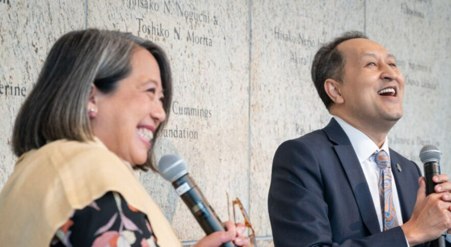 two people speaking into microphones
