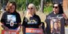 Three women hold signs opposing fentanyl.
